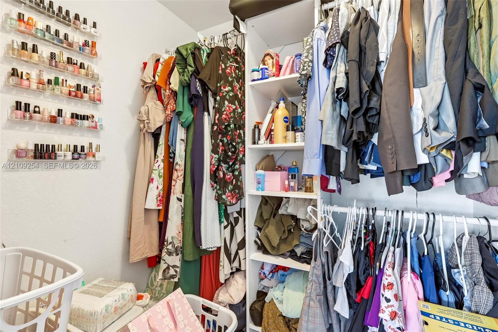 Custom-built closet system featuring vertical shelving and integrated hanging rods, complemented by wall-mounted tiered storage racks
