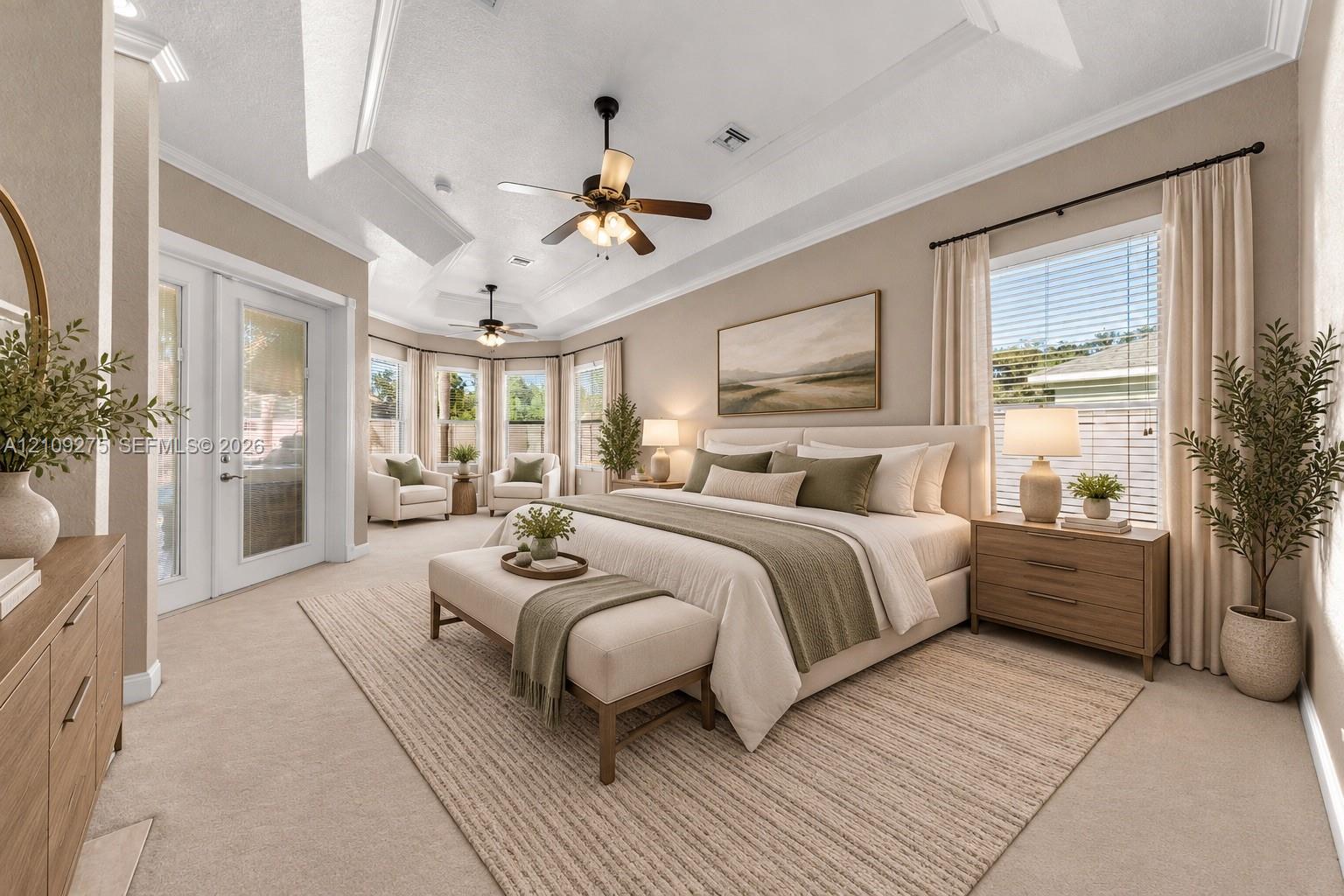 Tray ceiling, dual ceiling fans, recessed lighting, and expansive windows featuring glass door access to the exterior