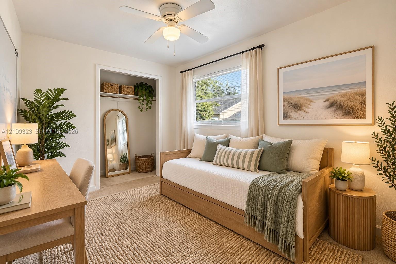Neutral interior featuring wall-to-wall carpeting, an open-concept reach-in closet, a ceiling-mounted light fixture with integrated fan, and a double-pane window with a rod-mounted curtain assembly