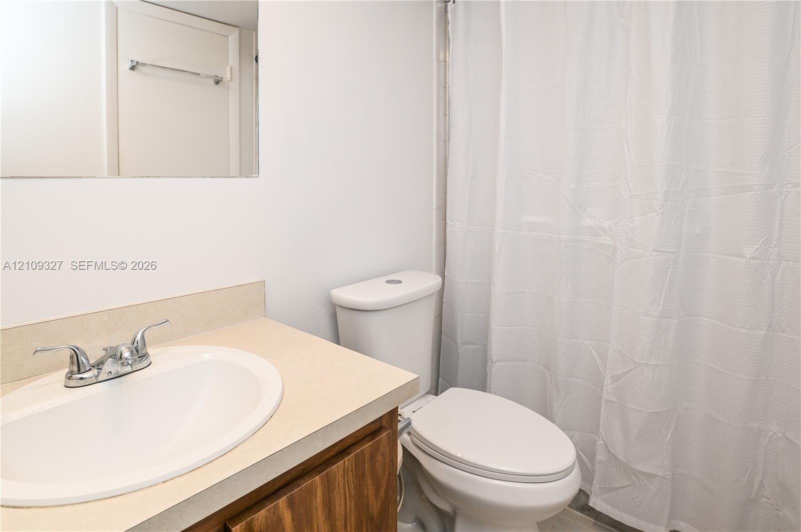 Vanity featuring integrated oval basin, and dual-handle chrome faucet