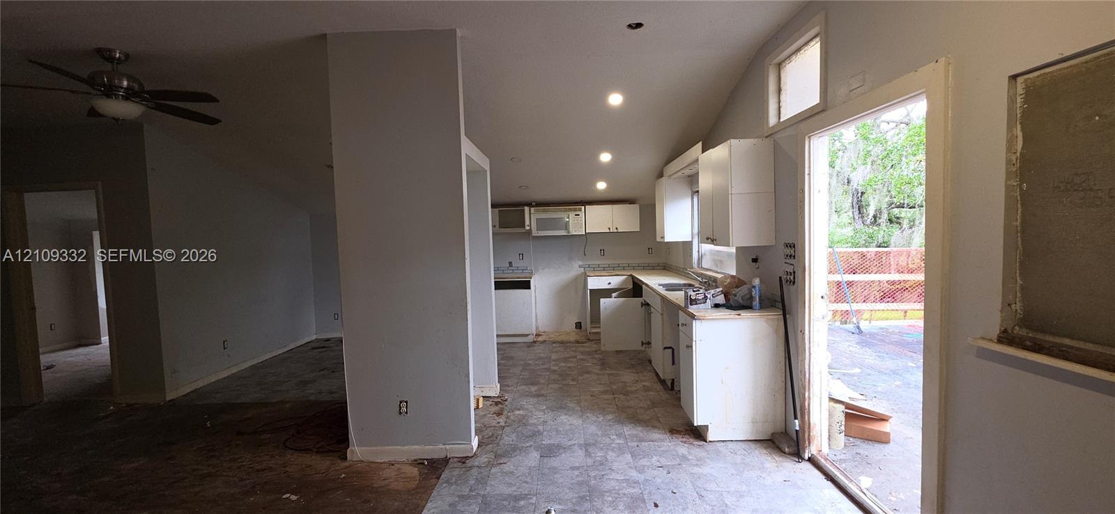 Kitchen featuring white cabinetry, recessed lighting, tile flooring, and a ceiling fan