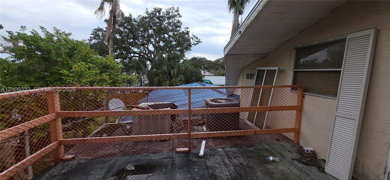 Exterior elevated deck featuring wood-framed railing with integrated wire mesh