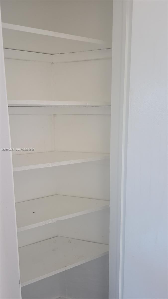 Built-in storage cabinet featuring five tiered shelves