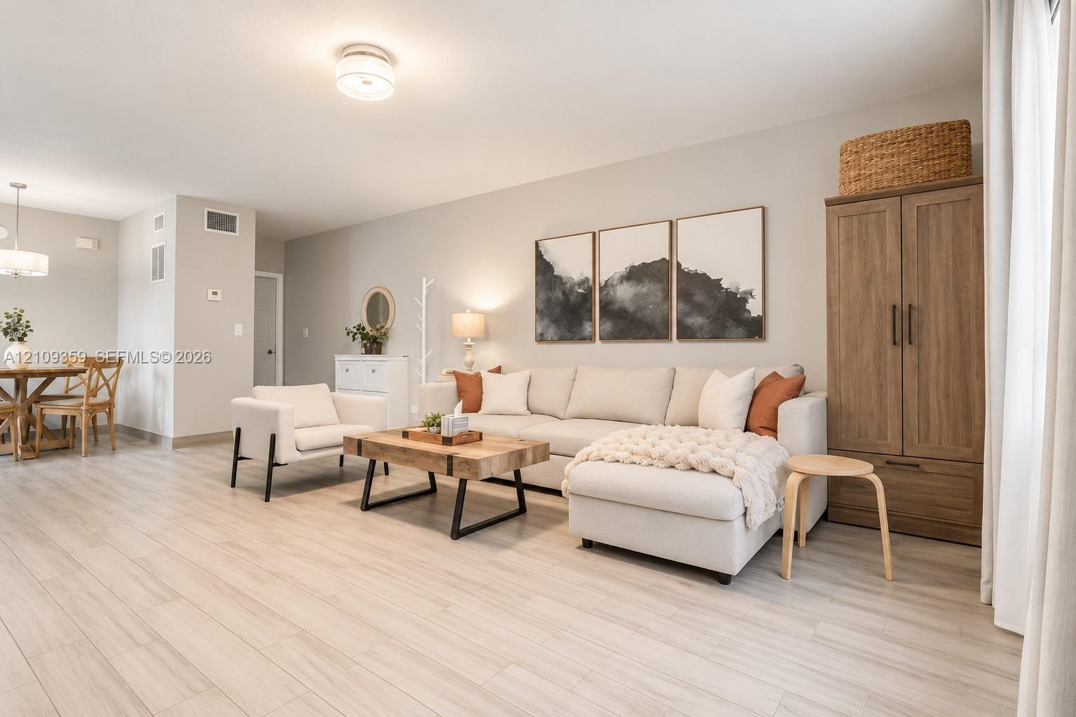 Open floor plan featuring wood-finish flooring, neutral wall color, and flush-mount ceiling lighting Open floor plan featuring wood-finish flooring, neutral wall color, and flush-mount ceiling lighting