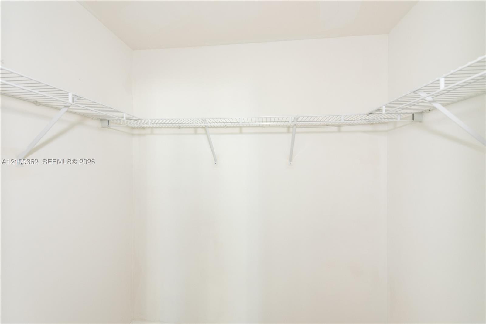 Walk-in closet featuring white wire shelving