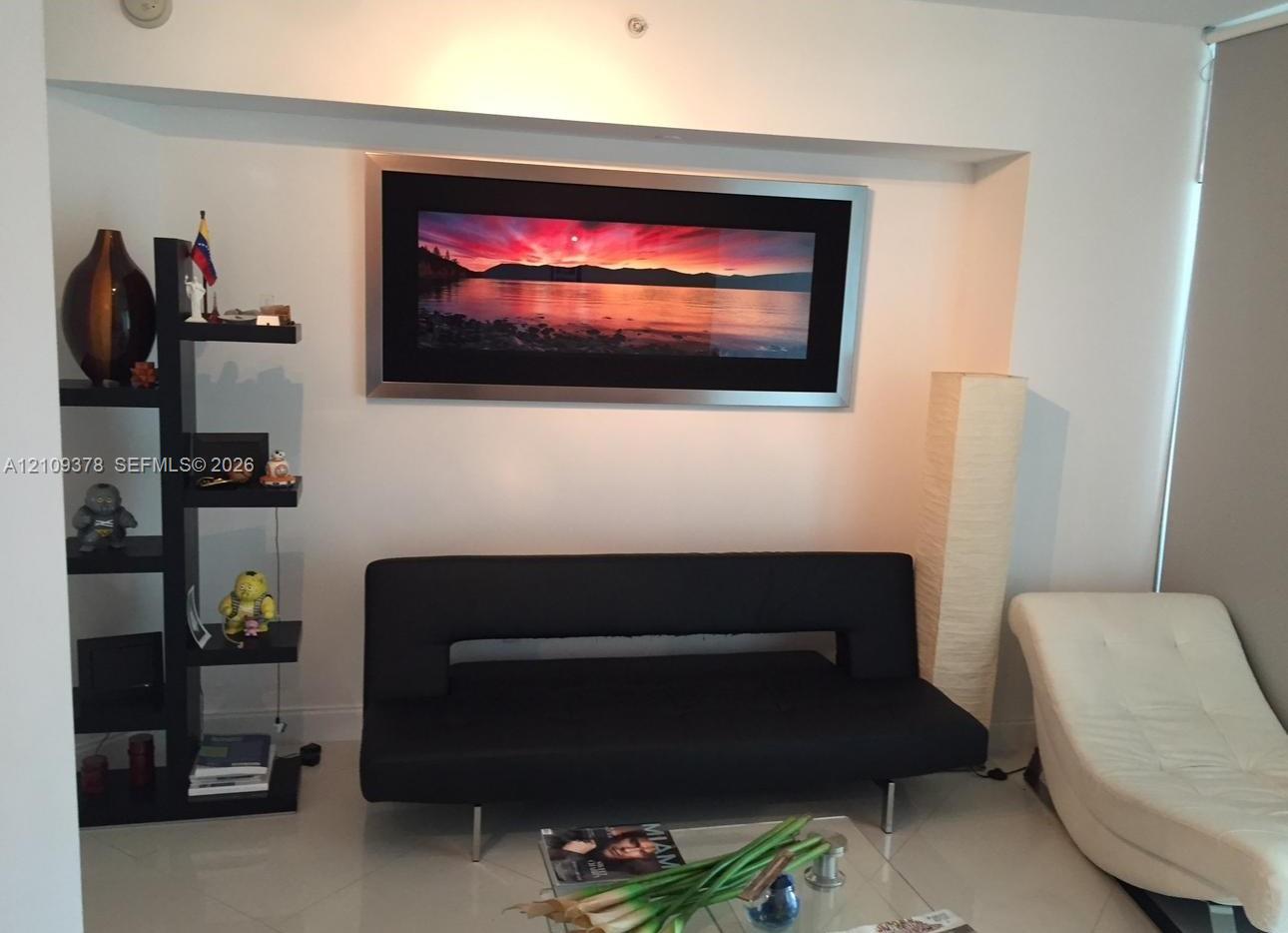 Interior wall featuring a recessed alcove and large-format tile flooring