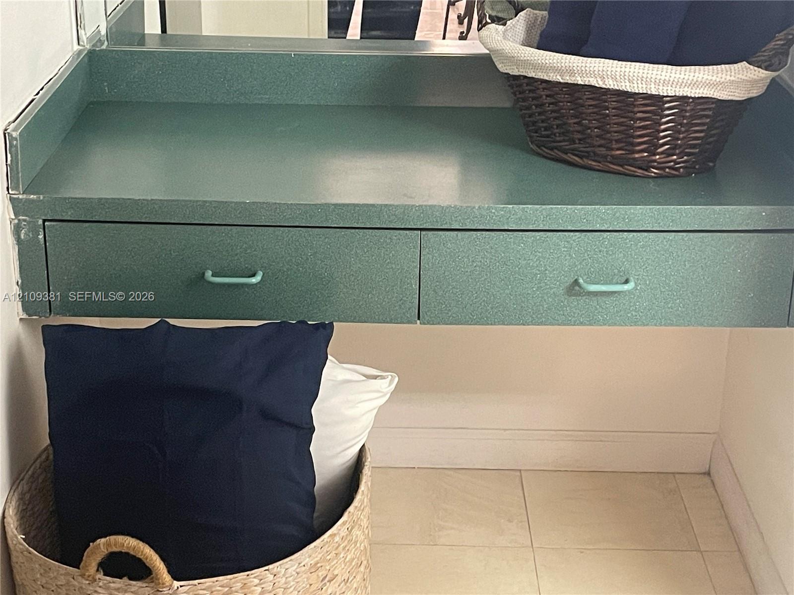 Wall-mounted light fixture, mirror, and neutral countertop