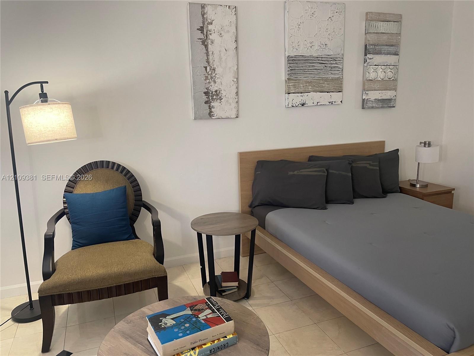Neutral interior space featuring polished tile flooring