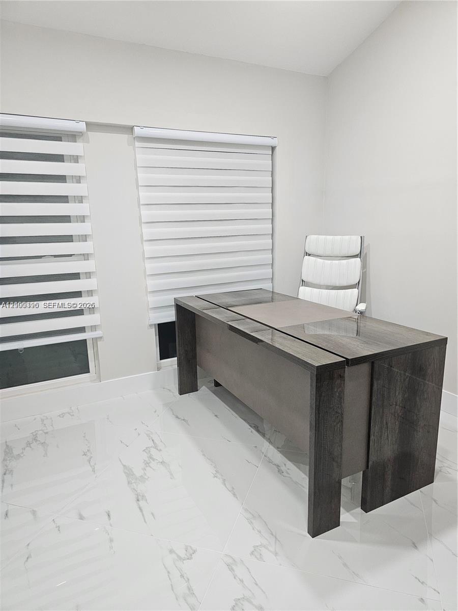 Polished white tile flooring with grey veining, dual windows, and adjustable horizontal window shades