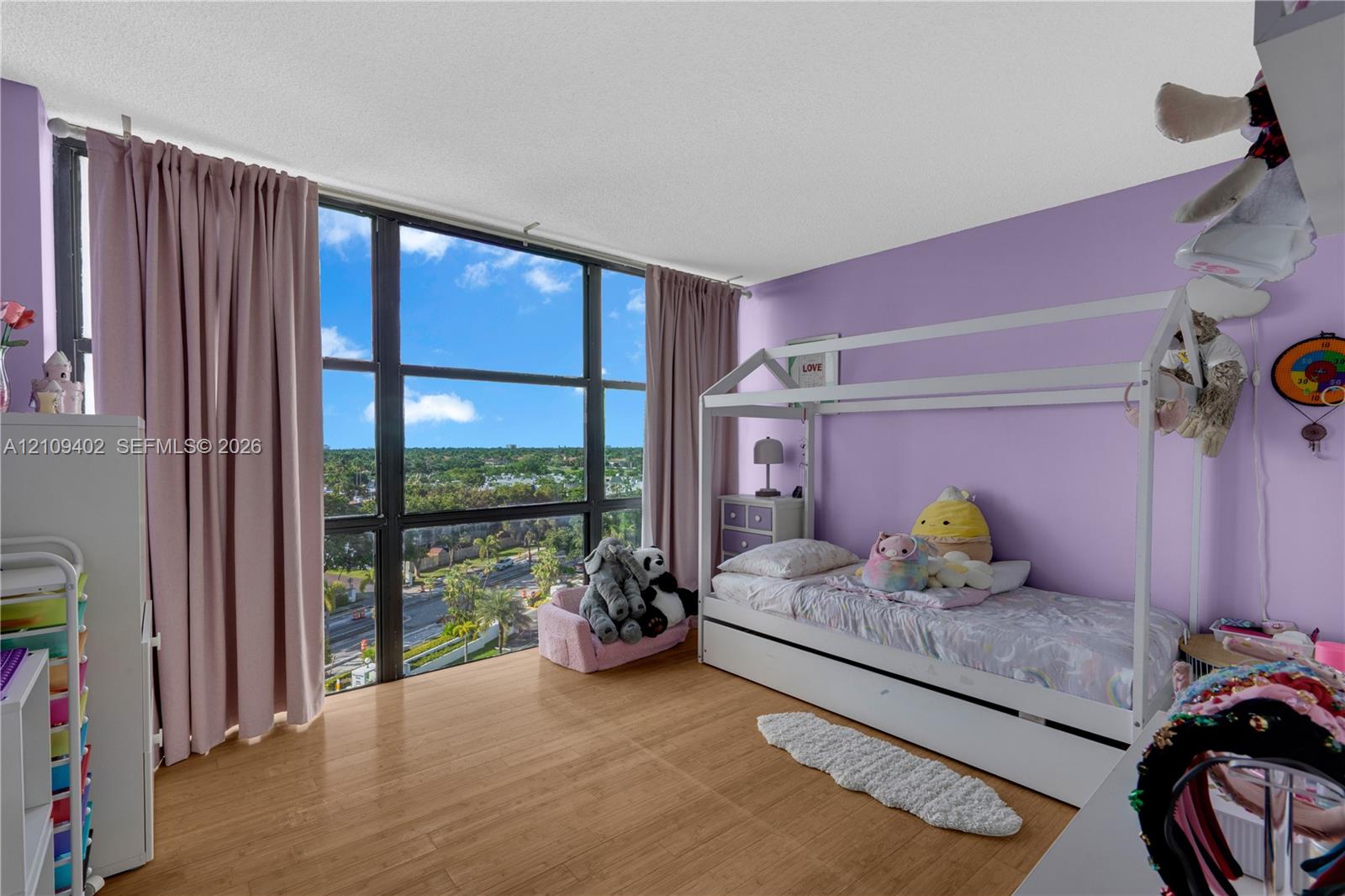 Floor-to-ceiling windows featuring panoramic exterior scenery and wood-finish flooring