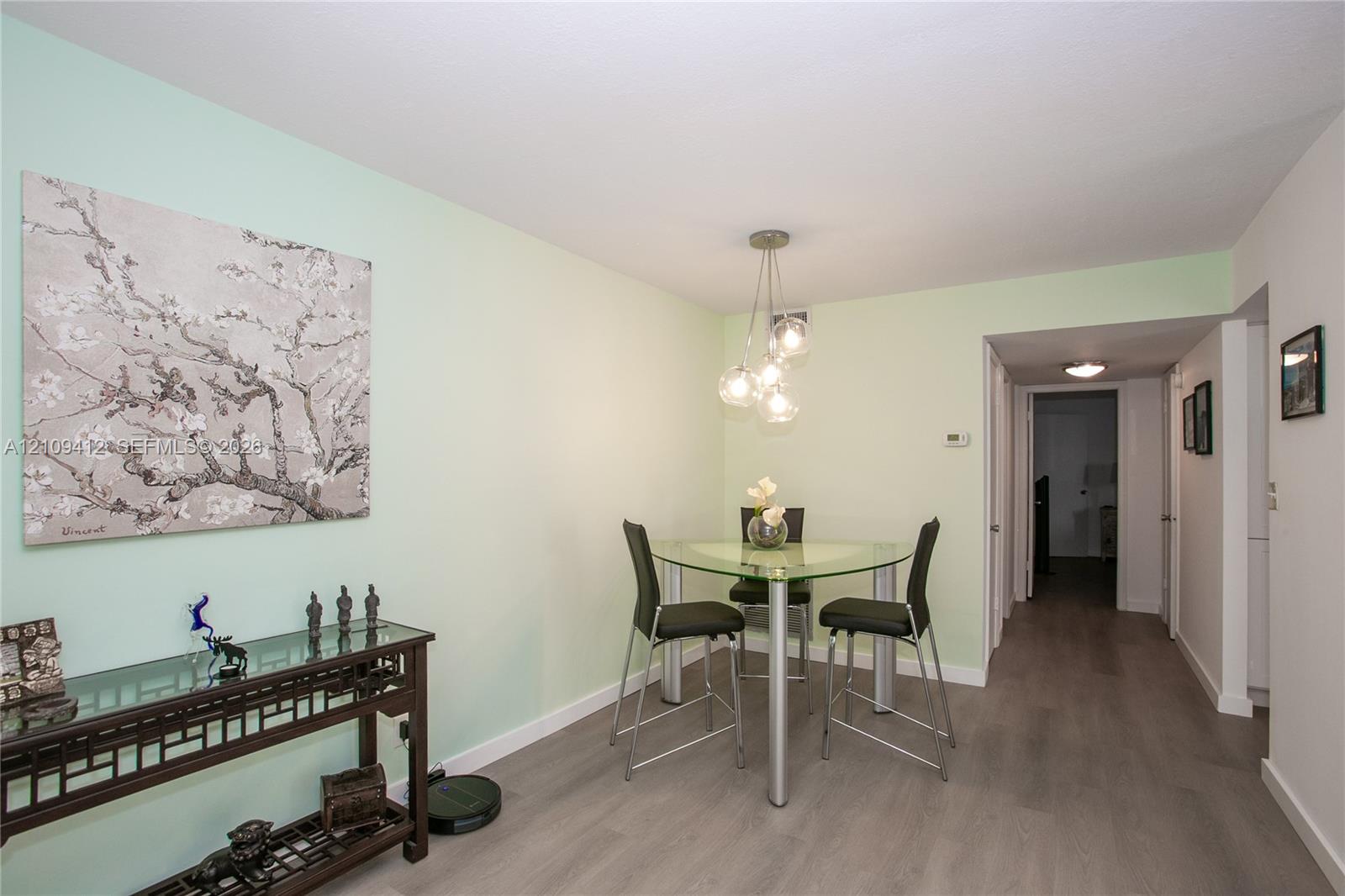 Interior space featuring wood-finish flooring and a multi-bulb spherical pendant light fixture