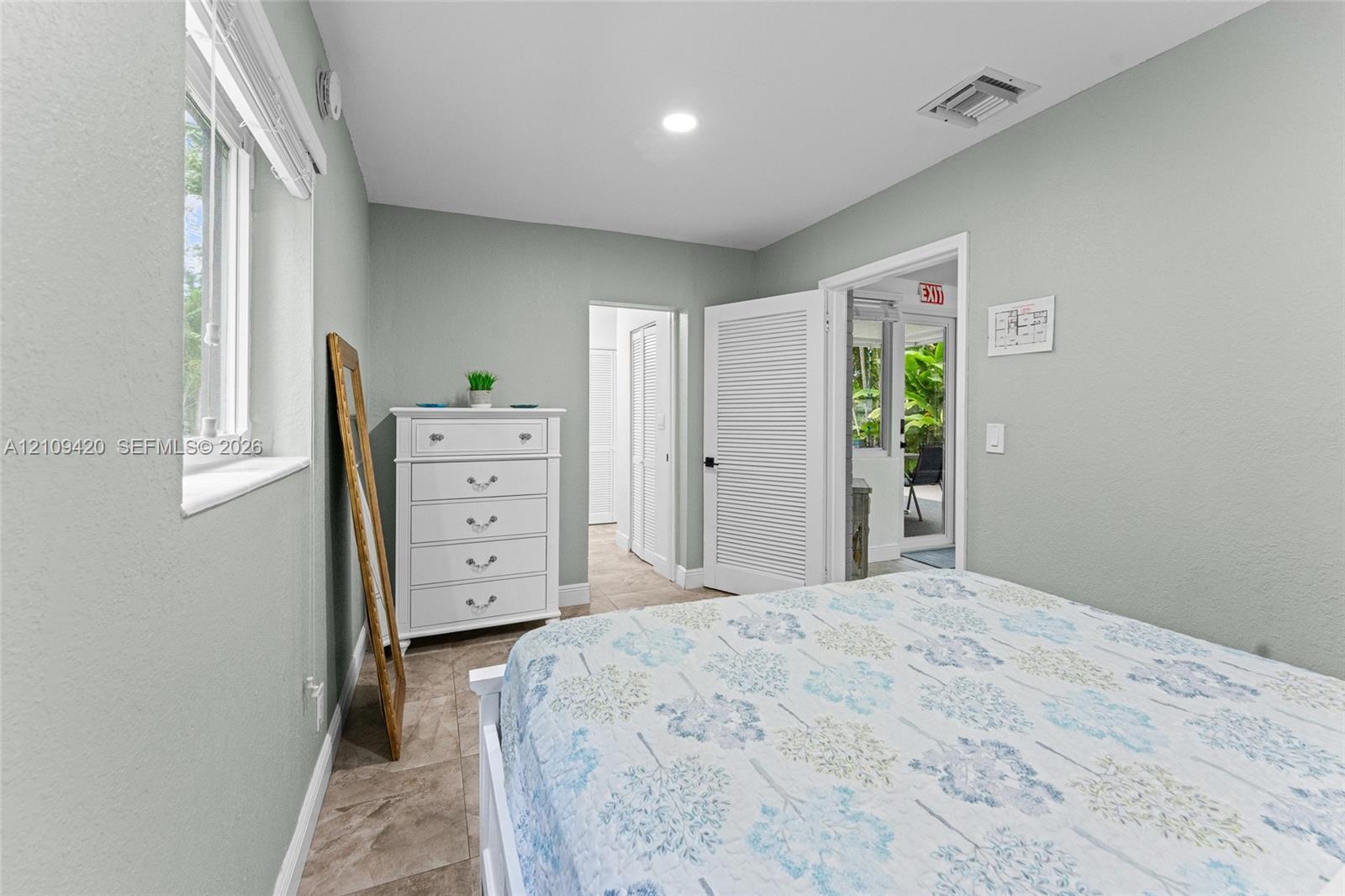 Room featuring tile flooring, neutral wall paint, a louvered closet door, and recessed lighting