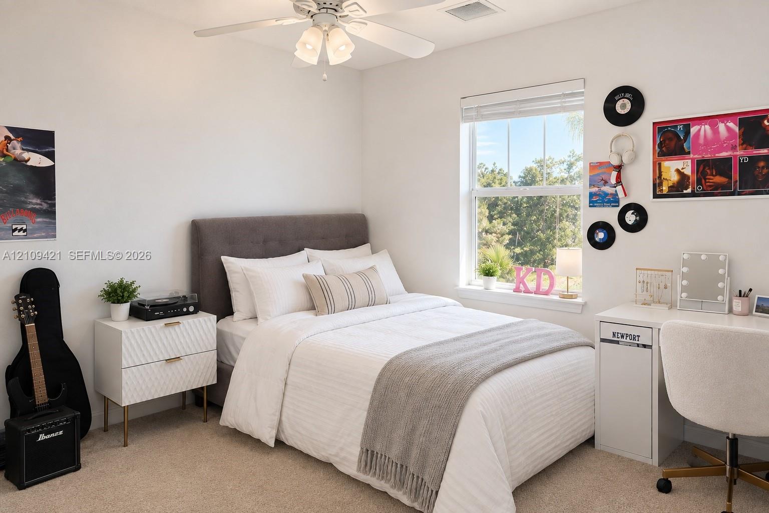 Neutral-toned wall-to-wall carpeting, ceiling-mounted light fixture with a three-blade fan, and single-pane window with a sill