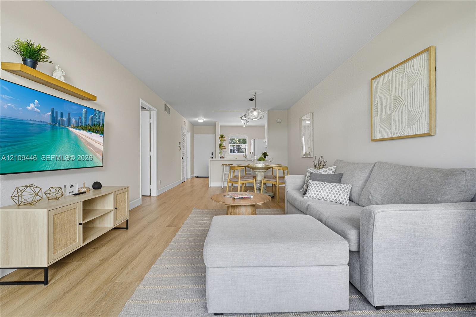 Open-concept interior featuring light wood-finish flooring, neutral wall tones, and recessed ceiling lighting Open-concept interior featuring light wood-finish flooring, neutral wall tones, and recessed ceiling lighting