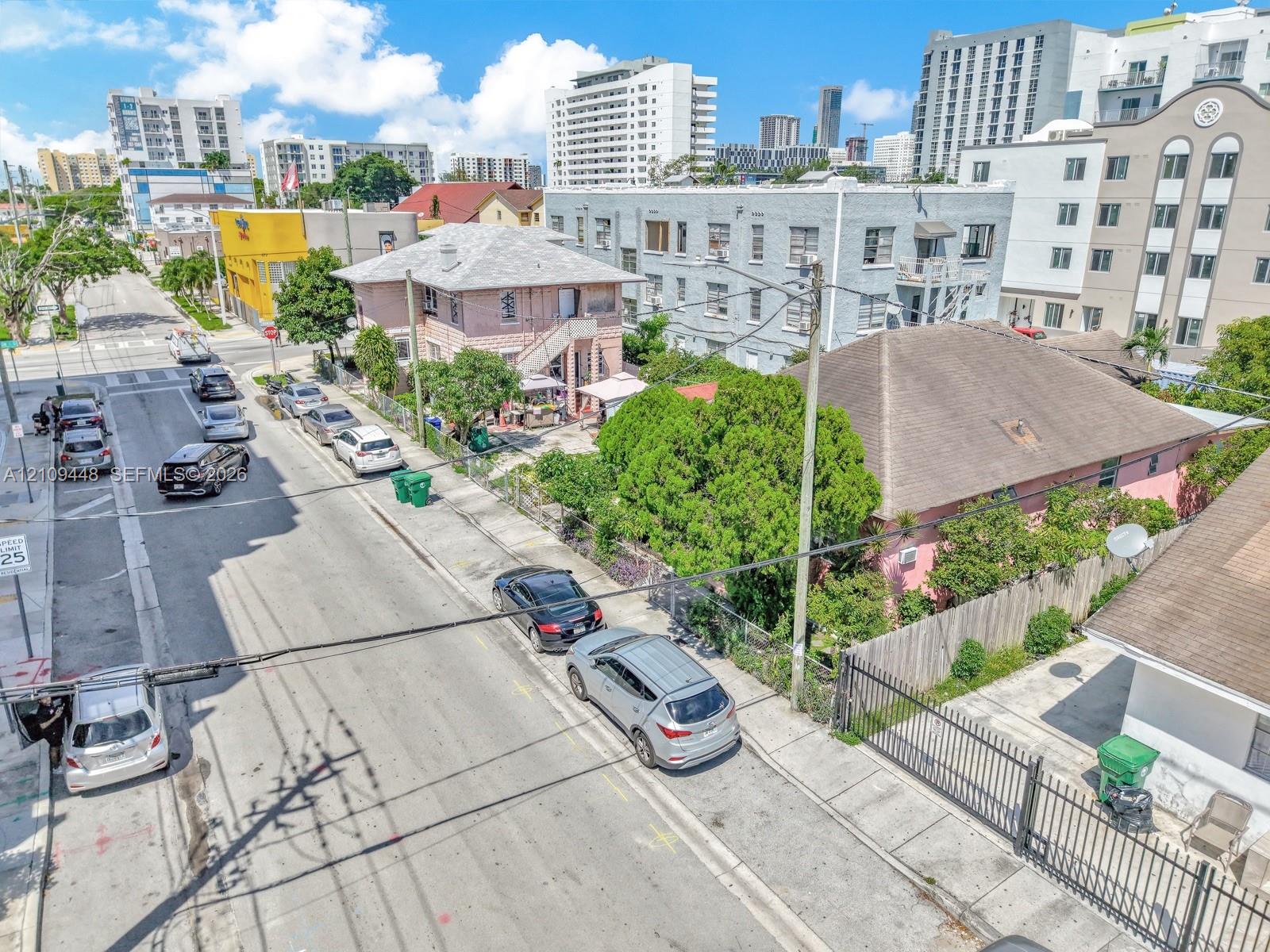 Corner lot property featuring a masonry exterior, private perimeter fencing, and established mature landscaping