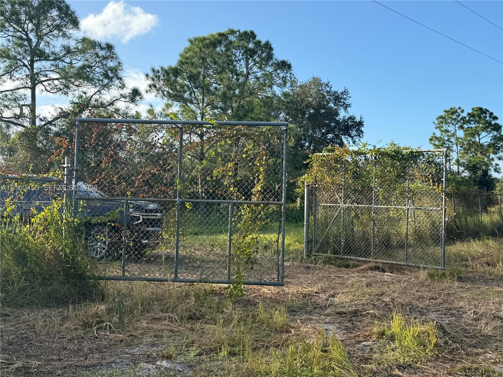 Chain-link perimeter fencing featuring dual metal entry gates