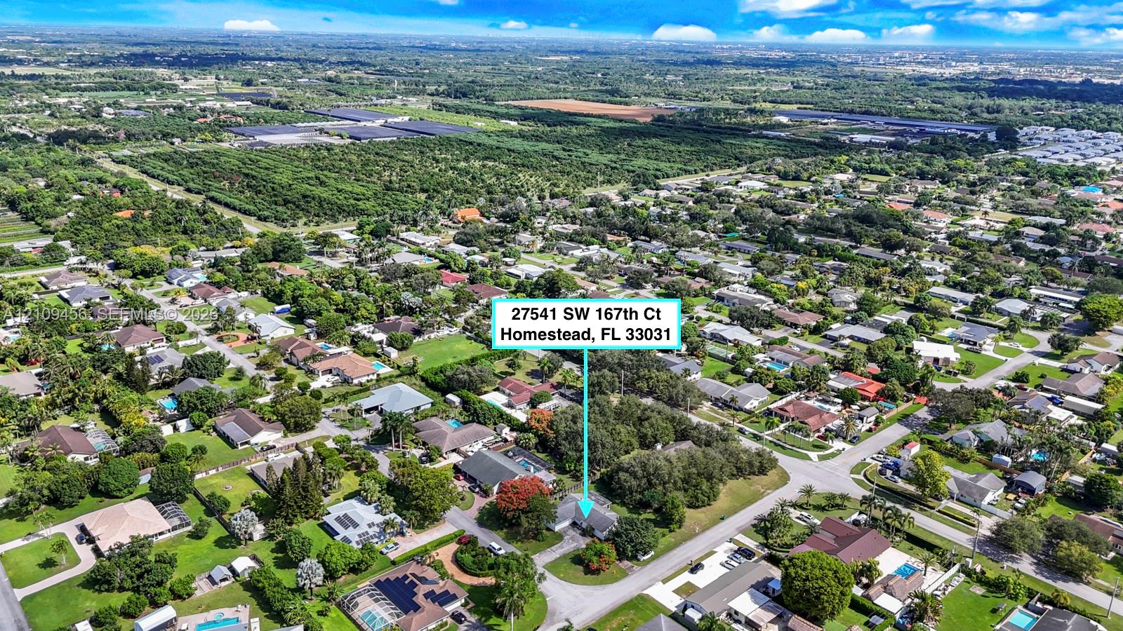 Aerial perspective of a residential property featuring extensive mature tree canopy, spacious grounds, and dense surrounding vegetation