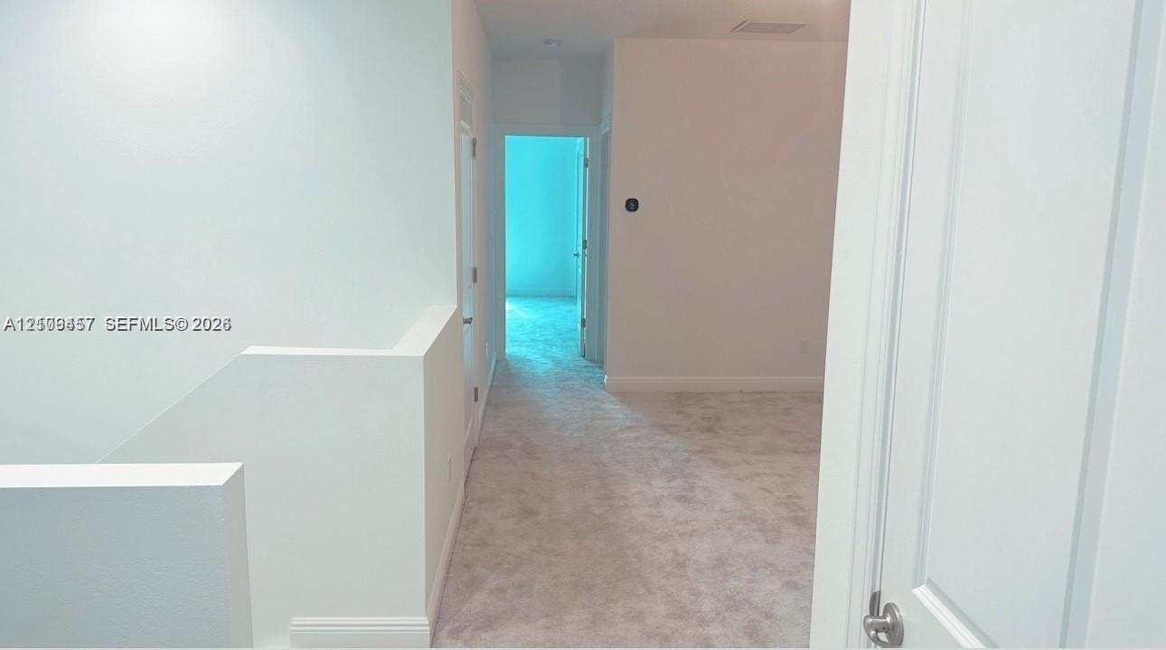 Neutral wall palette, carpeting, and multi-panel doors