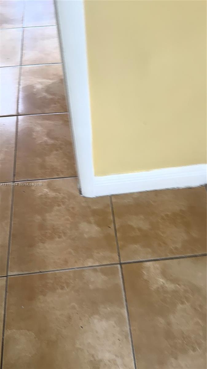 Large-format square ceramic tile flooring with a neutral-toned finish