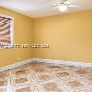 Room featuring ceramic tile flooring, horizontal window blinds, and a central ceiling fan with an integrated light fixture Room featuring ceramic tile flooring, horizontal window blinds, and a central ceiling fan with an integrated light fixture