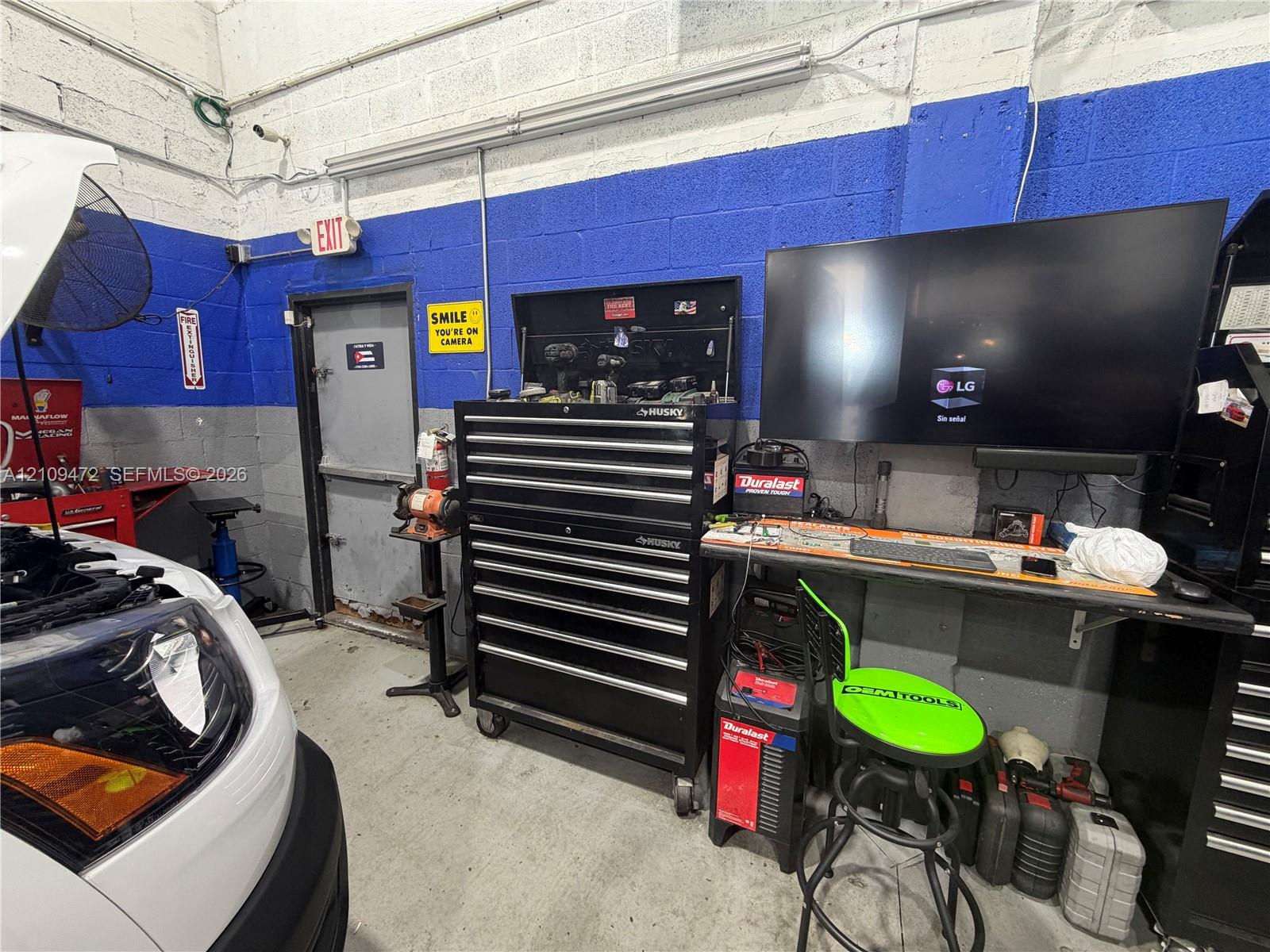Industrial workshop space featuring painted cinder block walls and concrete flooring
