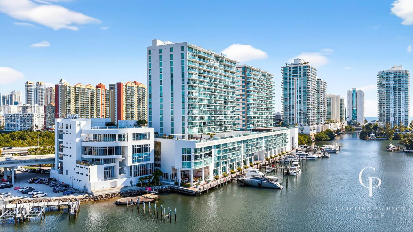 High-rise coastal architecture featuring glass-paneled balconies, floor-to-ceiling windows, and integrated boat slips along the waterfront