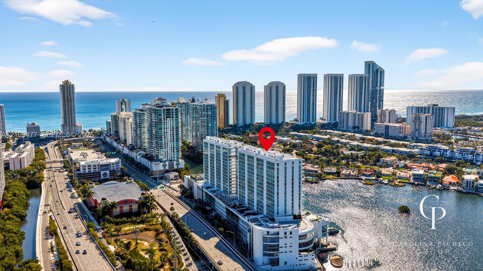 Aerial perspective of high-rise building situated on a waterway with prominent proximity to the coastline