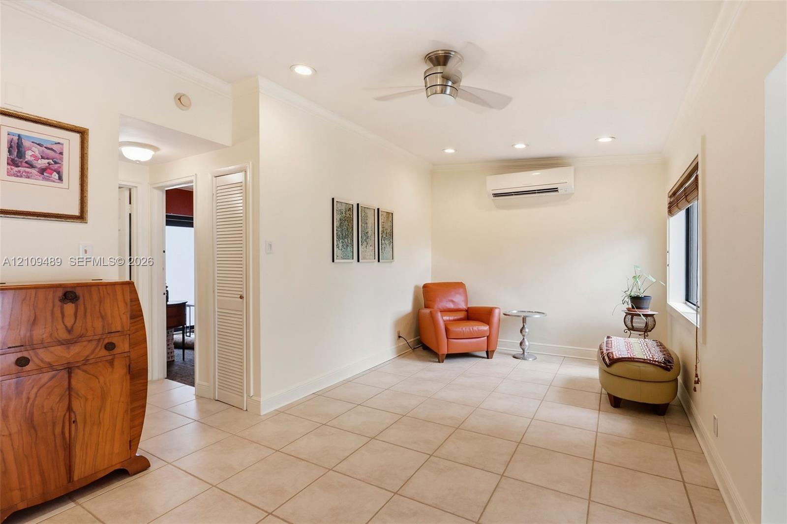 Ceramic tile flooring, recessed lighting, ceiling fan, and wall-mounted ductless air conditioning unit