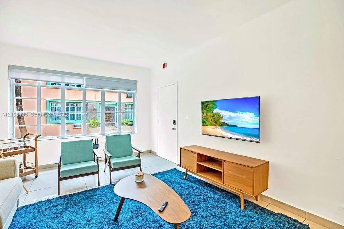 Interior space featuring large multi-pane windows and neutral-tone tile flooring