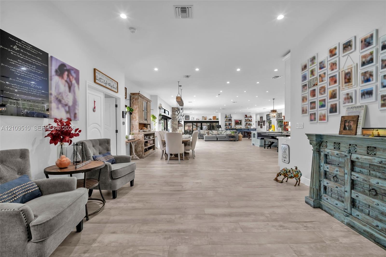 Open-concept interior featuring light wood-finish flooring, recessed lighting, and high ceilings Open-concept interior featuring light wood-finish flooring, recessed lighting, and high ceilings