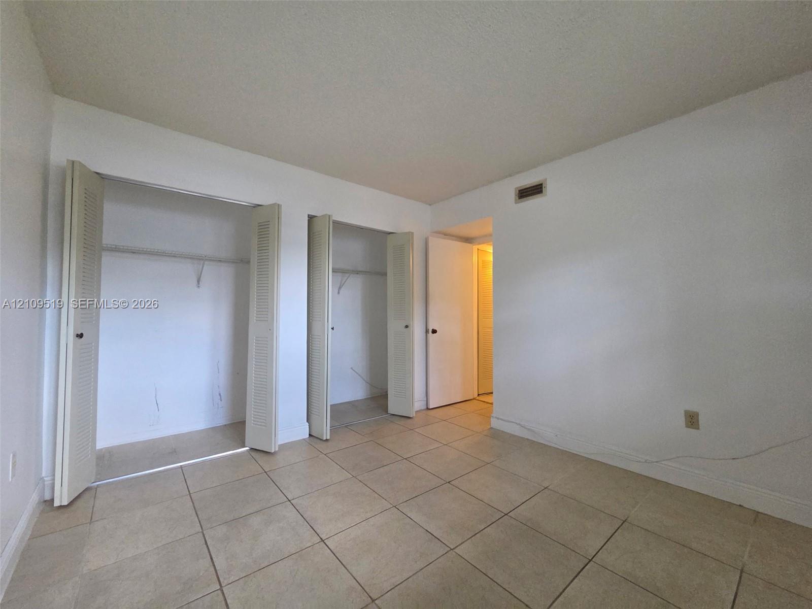 Second bedroom with natural light and two closets