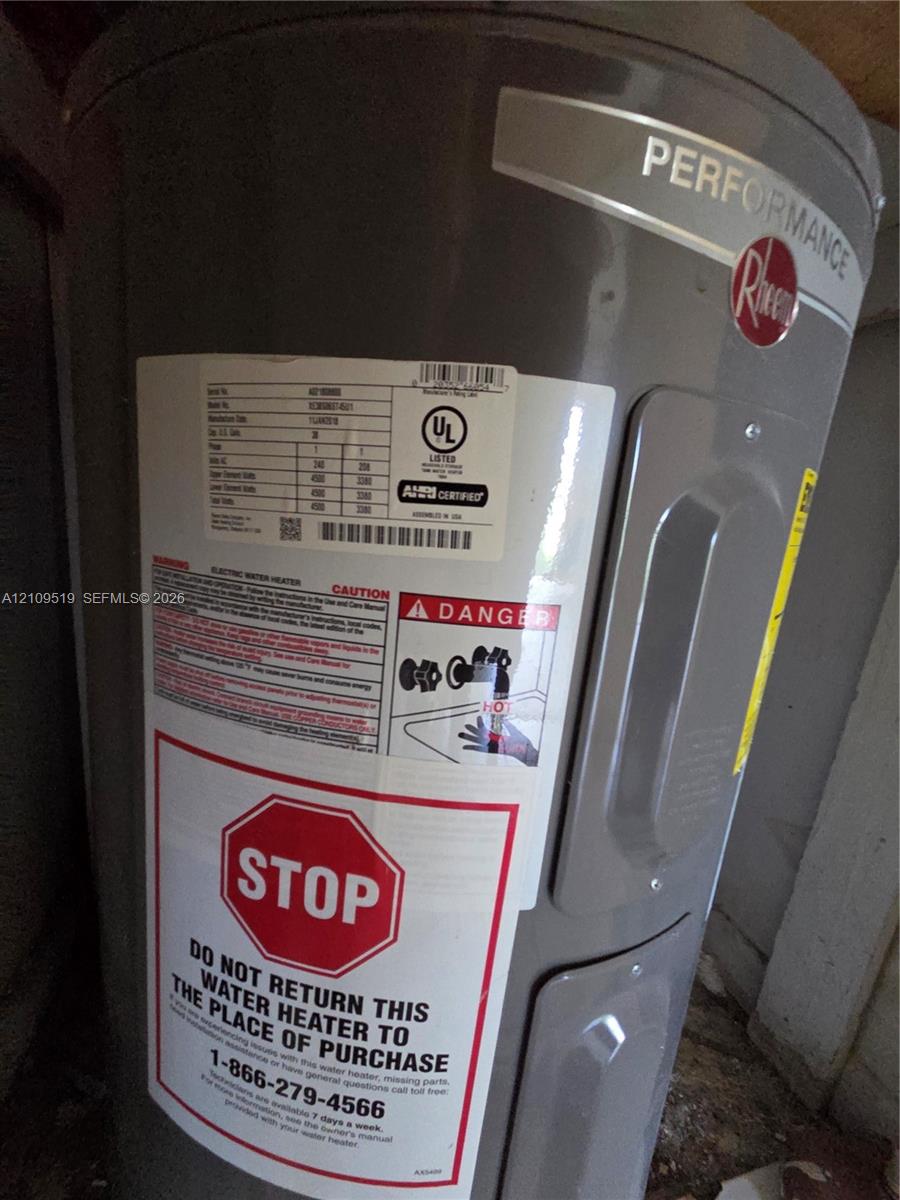 Rheem Performance electric water heater featuring a cylindrical steel tank design and factory-applied safety and identification labeling