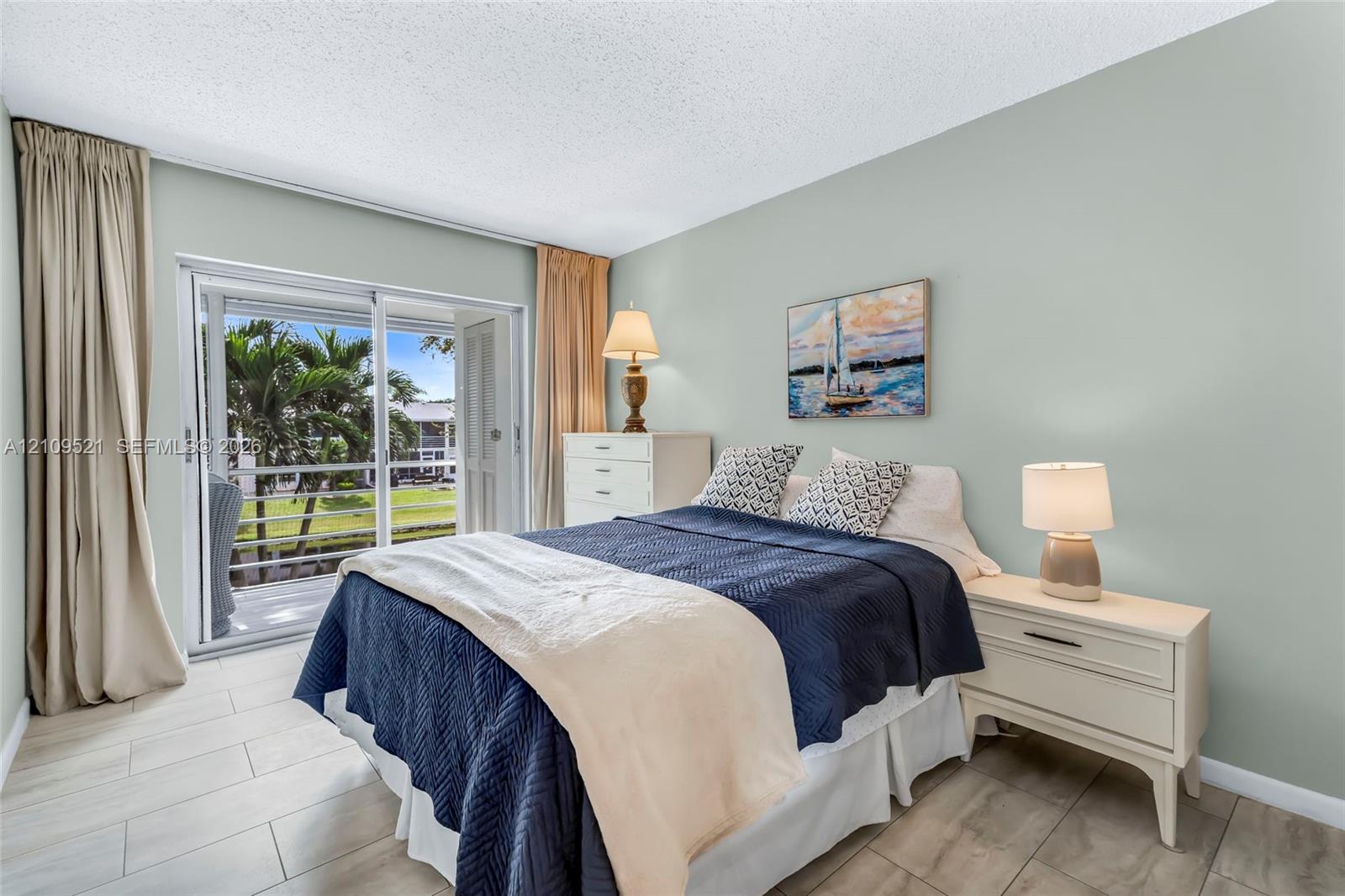 Room featuring large format tile flooring and glass sliding doors with access to an exterior balcony