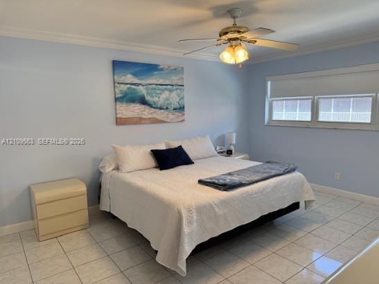 Room featuring neutral tile flooring, multi-light ceiling fan, and crown molding
