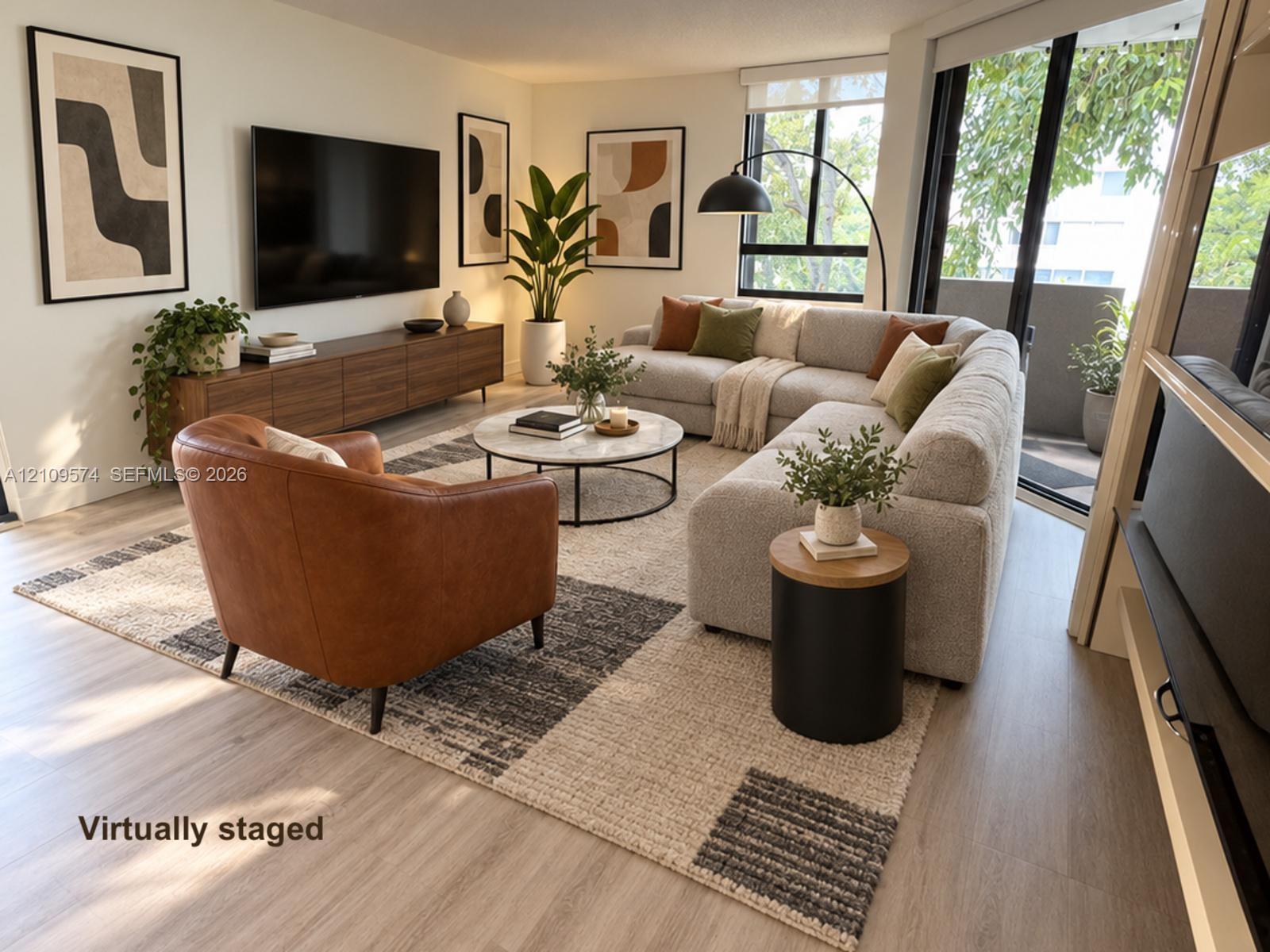 Staged. Vinyl Wood-finish flooring, floor-to-ceiling windows, and sliding glass door access to a private balcony Staged. Vinyl Wood-finish flooring, floor-to-ceiling windows, and sliding glass door access to a private balcony