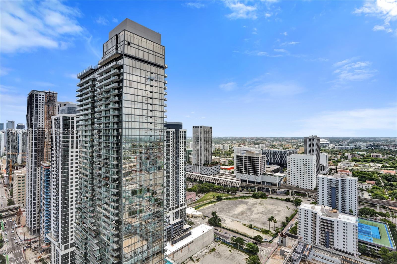 High-rise glass facade featuring floor-to-ceiling windows and recessed balconies
