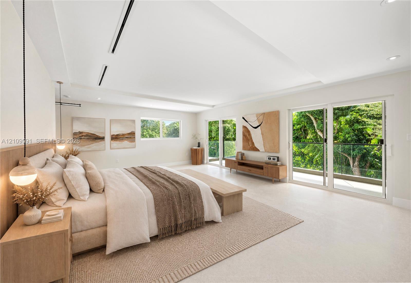Virtually Staged: Spacious room featuring tray ceiling, recessed lighting, dual pendant fixtures, and glass sliding doors with access to an exterior balcony