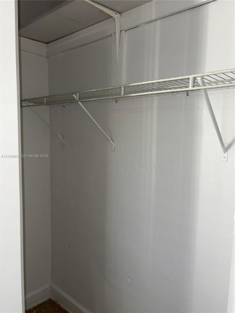 Closet featuring upper and lower wire shelving with structural support brackets