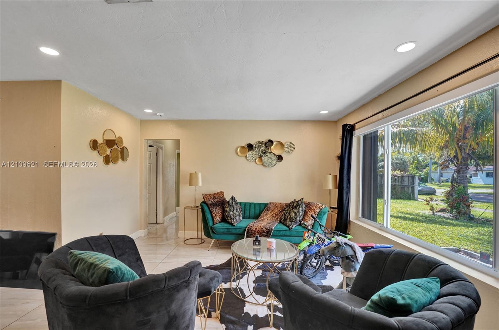 Interior space featuring tile flooring, recessed lighting, and a large picture window