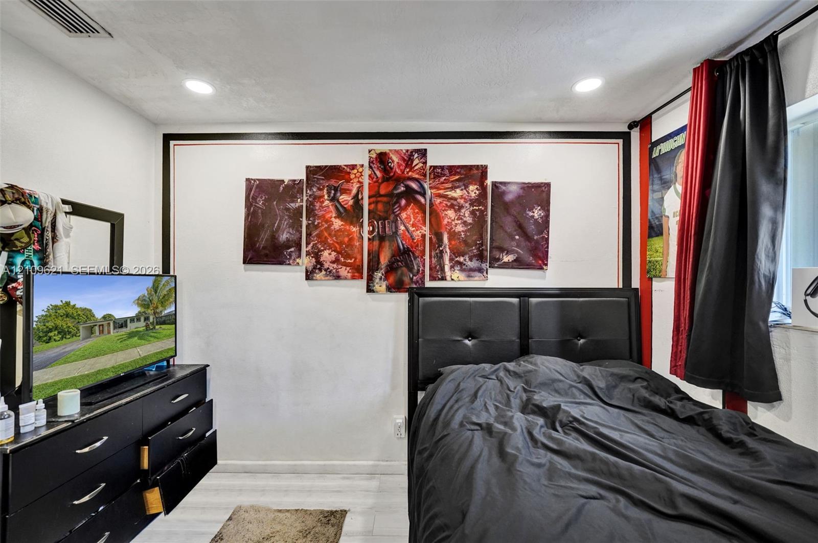 Neutral-toned room featuring recessed ceiling lighting and light-toned wood-finish flooring