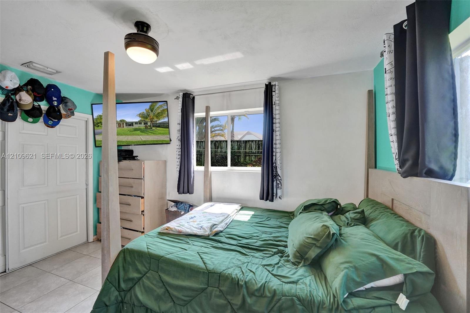 Tile flooring, neutral wall finishes, and a single-light ceiling-mounted fixture
