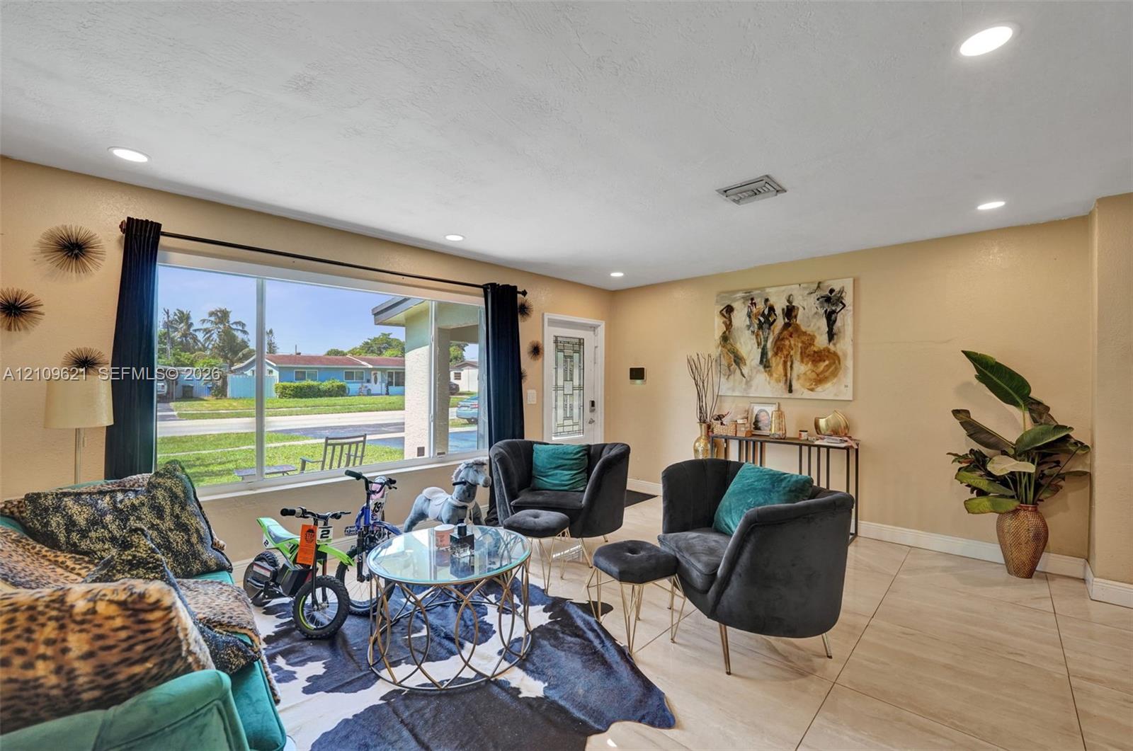 Large-format picture window, recessed lighting, and tile flooring