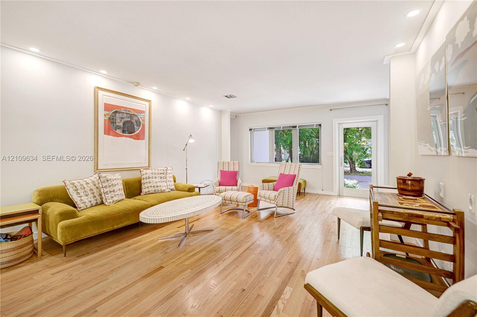 Open-concept space featuring wood-finish flooring, recessed lighting, and a glass-paneled exterior door