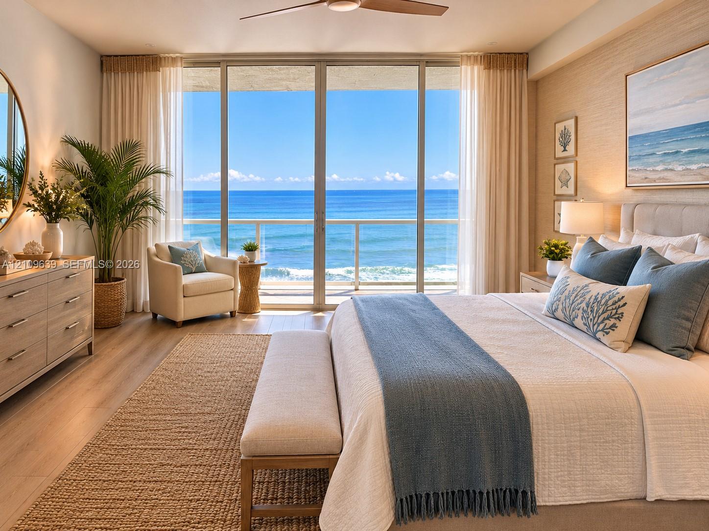 Floor-to-ceiling glass sliding doors, ocean backdrop, wood-finish flooring, textured wall covering, and integrated ceiling fan