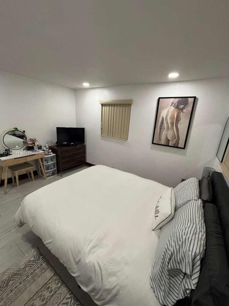 Neutral-toned walls, recessed lighting, and wood-finish tile flooring Neutral-toned walls, recessed lighting, and wood-finish tile flooring