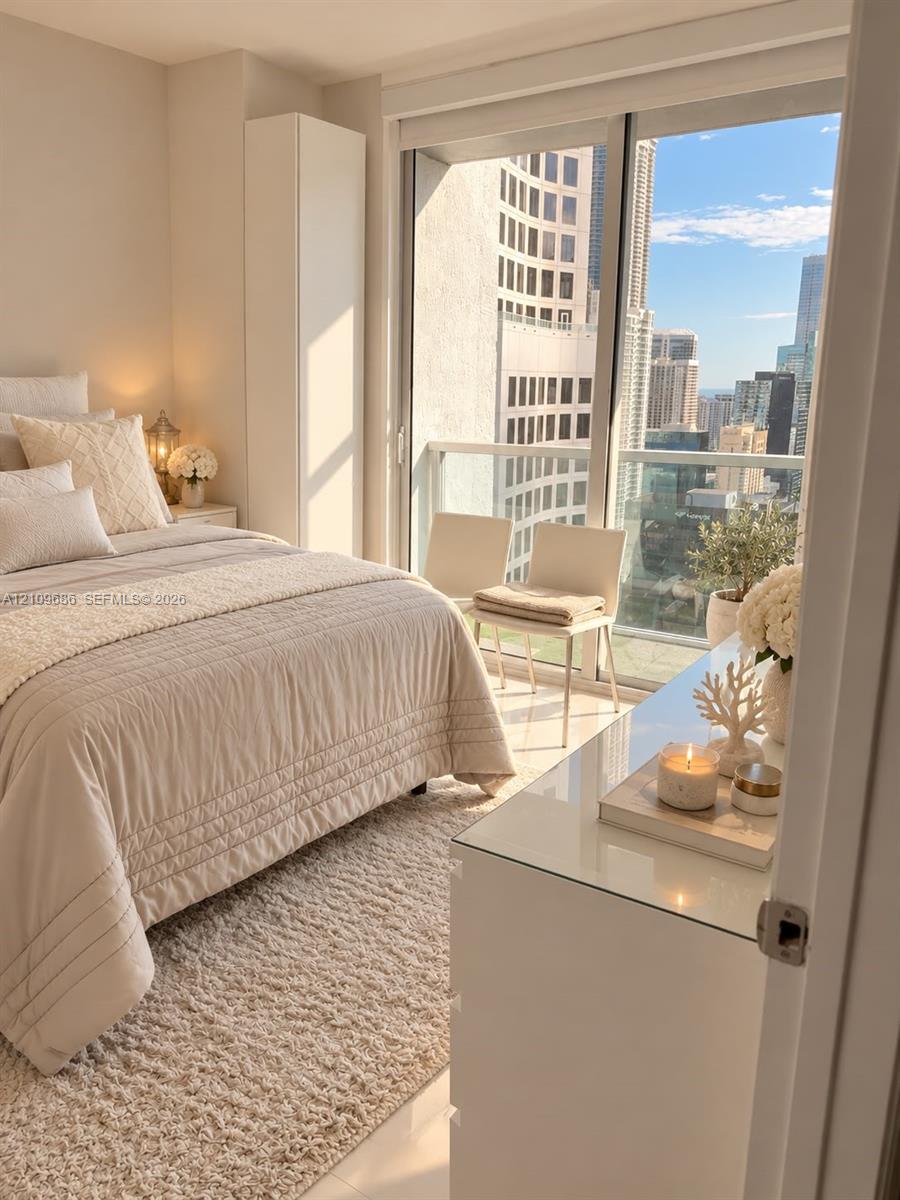 Floor-to-ceiling glass sliding doors, private balcony with metal railing, and built-in vertical cabinetry