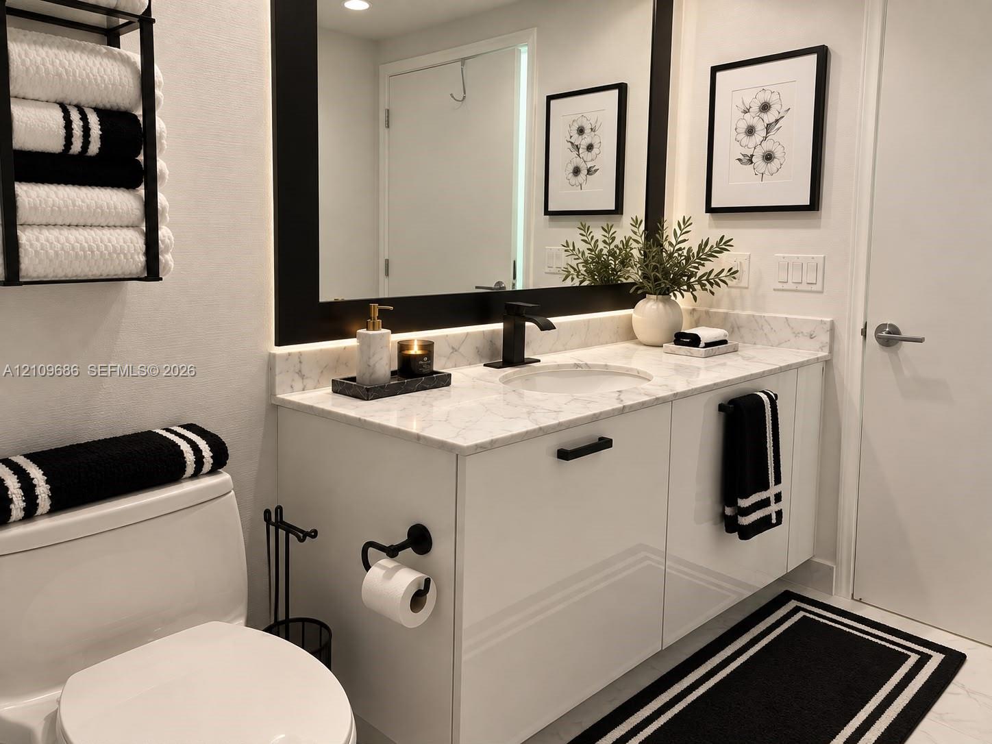 Modern floating vanity with a light-toned stone countertop, integrated sink, matte black faucet, and sleek flat-panel cabinetry