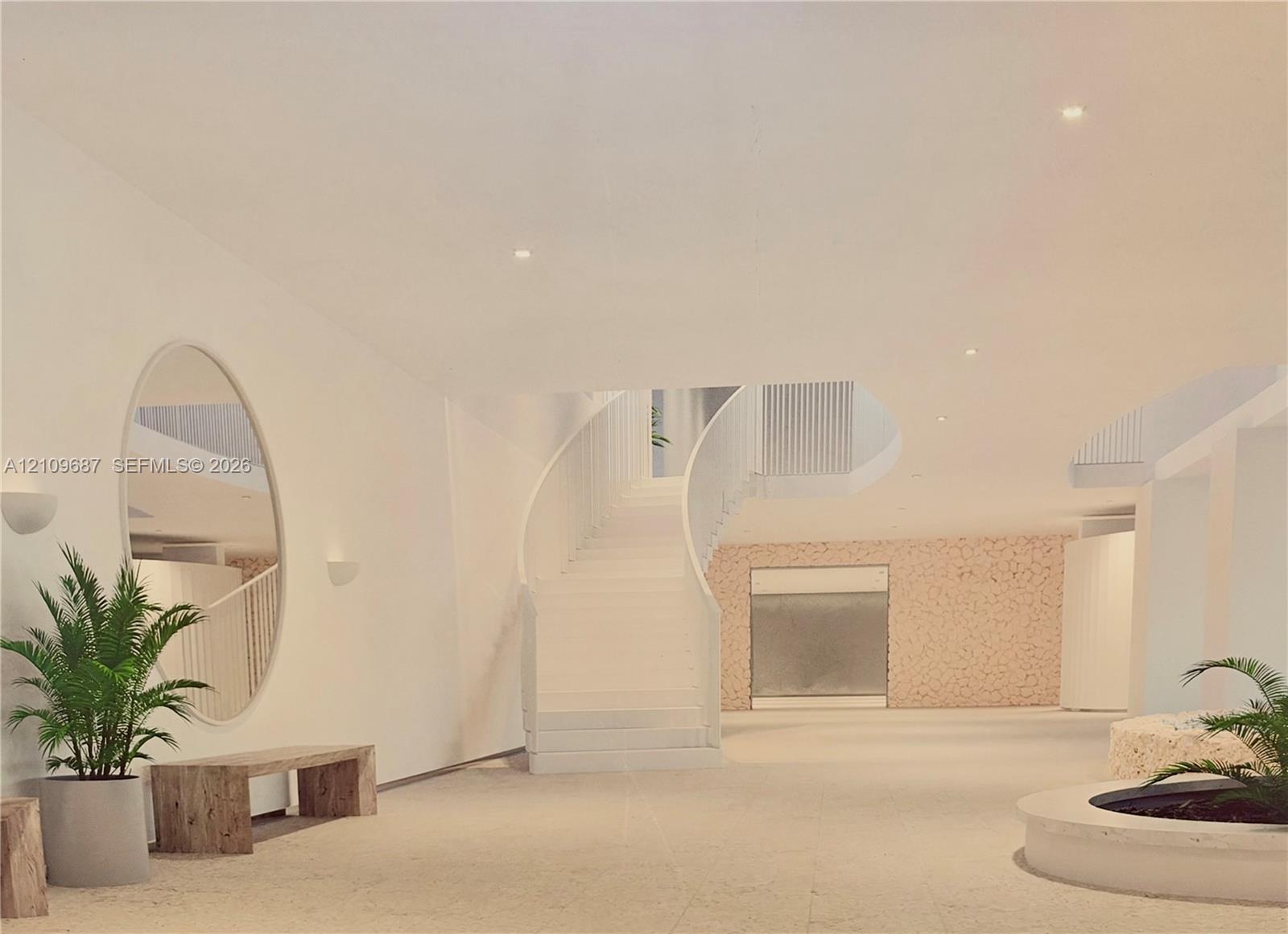 Curved architectural staircase with integrated railing, recessed ceiling lighting, textured stone-finish accent wall, and polished stone flooring
