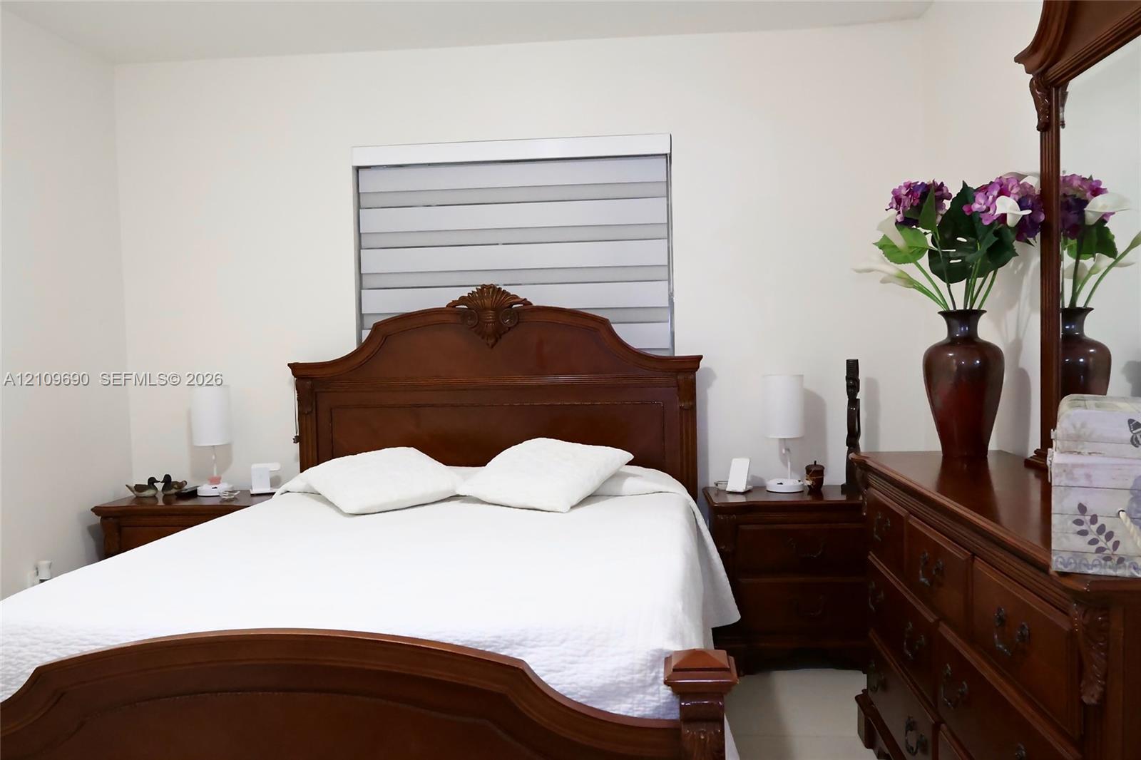 Neutral wall finishes and a dual-shade roller window treatment