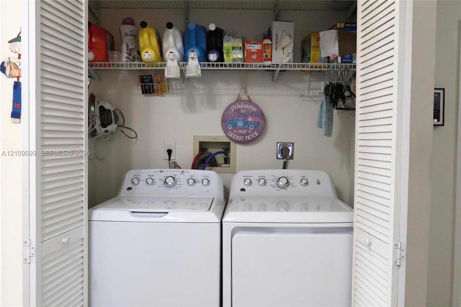 Laundry closet featuring bi-fold louvered doors and wire shelving